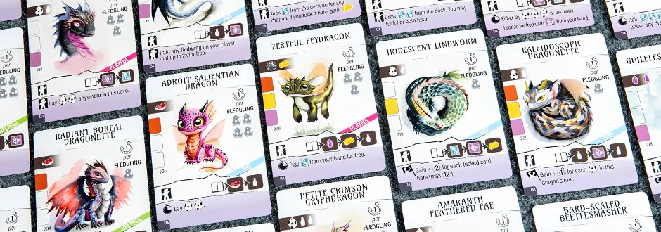 A collection of colorful fantasy creature cards displayed in a grid. Each card features a unique dragon or mythical creature with abilities and stats.