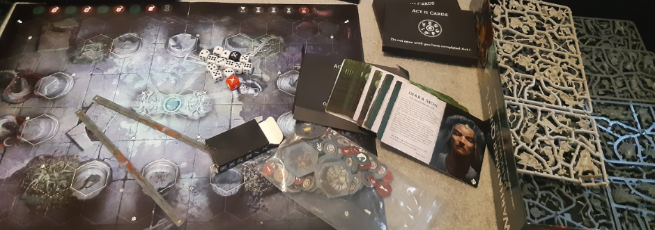 spread of Warhammer Quest: Darkwater components across a wooden table