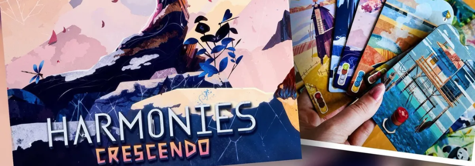Box of the game "Harmonies Crescendo" featuring vibrant, abstract mountain and plant art. A hand holds colorful illustrated cards, evoking excitement.