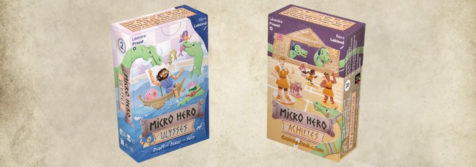 Two colorful board game boxes are displayed. The left box is blue-themed with a cartoonish ship and monster, labeled "Mikro Hero Ulysses." The right box is purple-themed with ancient Greek warriors, labeled "Mikro Hero Achilles." 