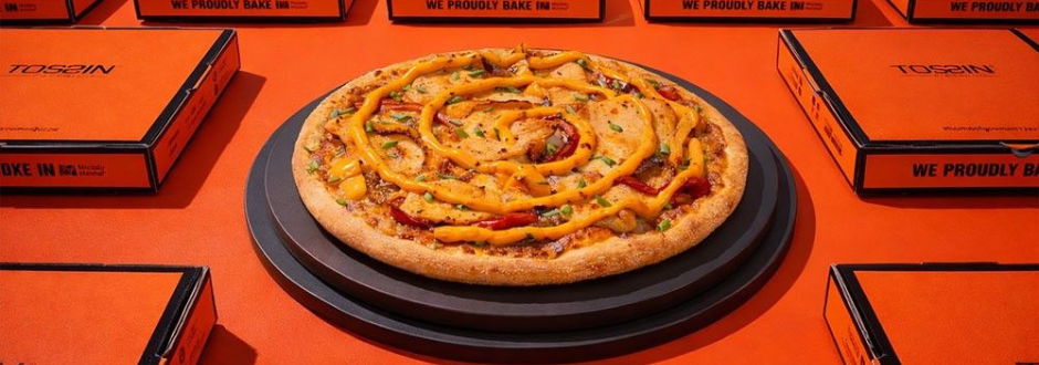 A pizza surrounded by boxes