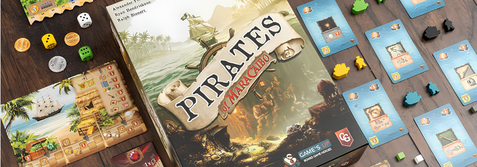Board game "Pirates of Maracaibo" box on a wooden table surrounded by game pieces, coins, dice, and cards depicting pirate-themed illustrations.