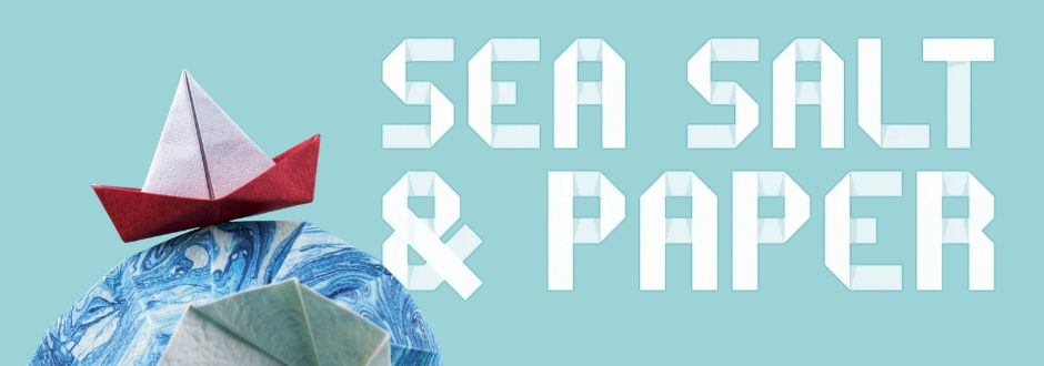 Origami boats on a blue marbled background with bold, white text reading "Sea Salt & Paper." The tone is creative and nautical.