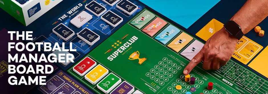 A person plays the "Superclub" football manager board game. The green board is filled with cards, dice, and colorful player pieces, conveying excitement.