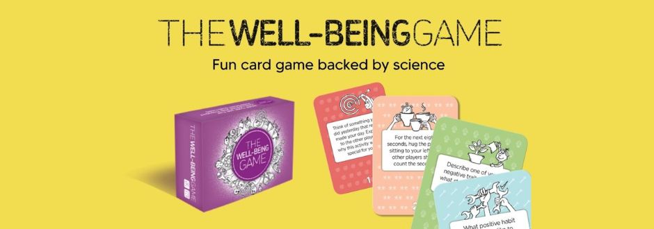Box of "The Well-Being Game" with colorful cards displayed on a yellow background. Text reads: "Fun card game backed by science."