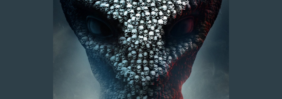 Dark, surreal image of an alien-like face formed from hundreds of small skulls, with deep-set eyes and moody, shadowy lighting.