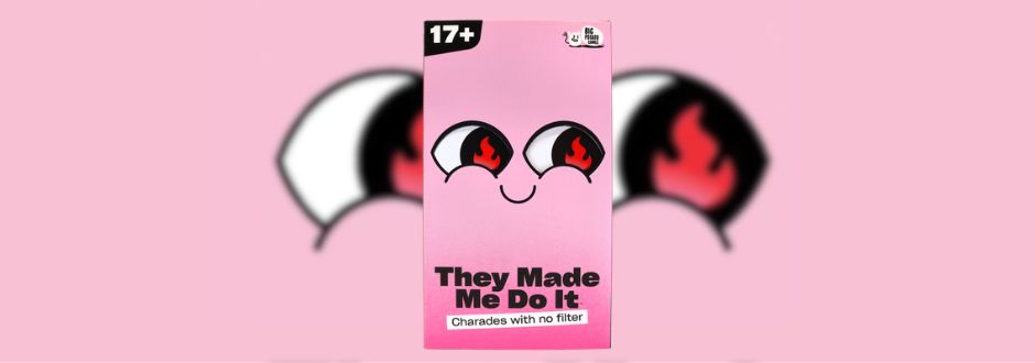 Pink game box with eyes and flames design. Text reads "They Made Me Do It: Charades with no filter" for ages 17+. Fun and edgy tone.